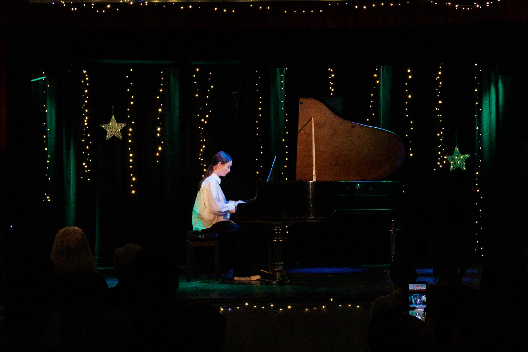 widok na scenę , dziewczyna, dziecko gra na fortepianie, w tle scena, oświetlona, kolorowa